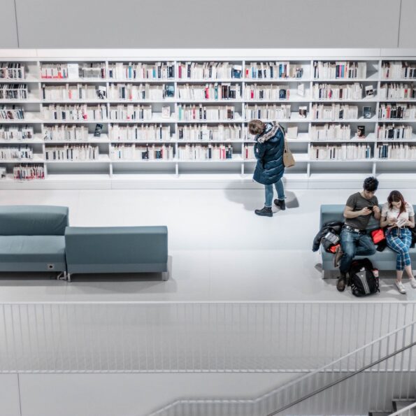 White library interior with people browsing